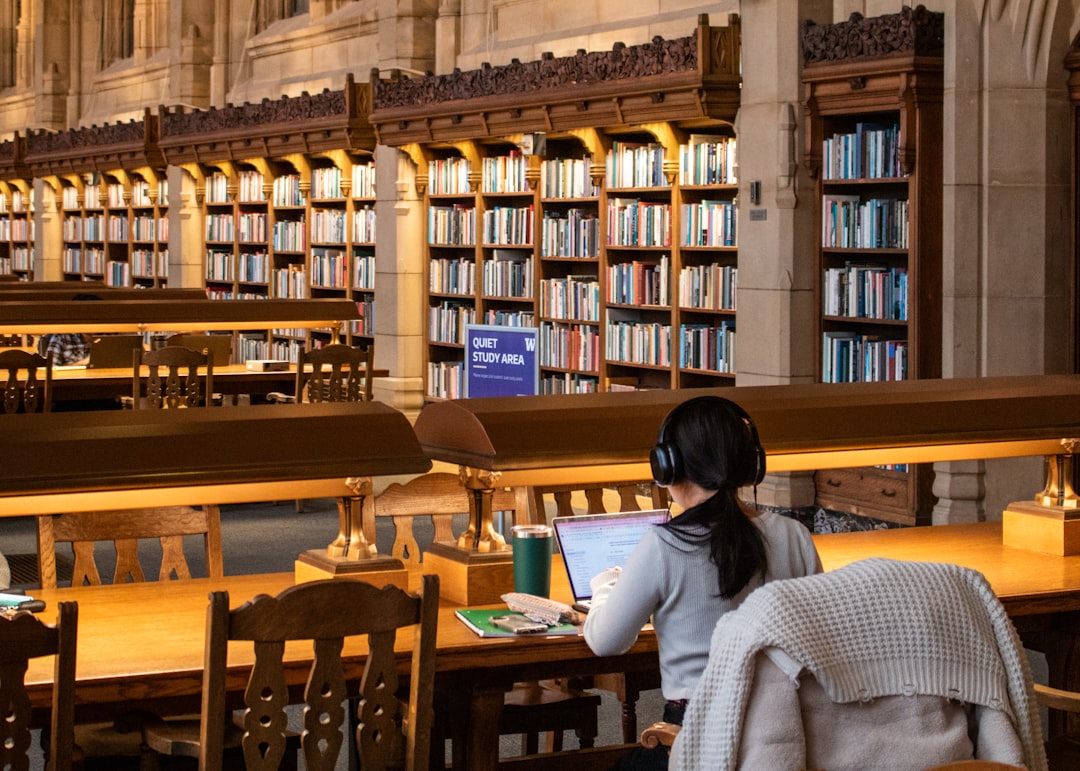 A student studies in a large, old library.
